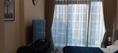 a bedroom with a bed and a window with curtains at Studio Uni at Azizi Riviera 43 Near Business Bay in Dubai