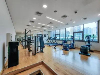 a gym with treadmills and cardio equipment in a building at Elegant 1BR at Sparkle T1 With Marina View Near Beach in Dubai