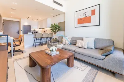 a living room with a couch and a table at Delightful 1BR in Binghatti Corner, Jumeirah Village Circle by Deluxe Holiday Homes in Dubai