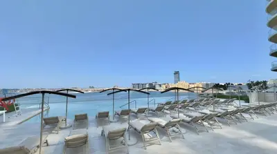 a group of chairs sitting on the beach at Grand Bleu 02 - LIMITED OFFER! 1BR Coastal Retreat at Emaar Beachfront in Dubai