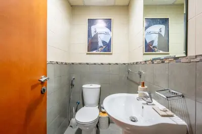 a bathroom with a toilet and a sink and a mirror at GuestReady - Coastal vibes in Dubai Marina in Dubai