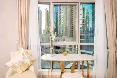 a table in a room with a large window at Elite Royal Apartment - Full Burj Khalifa & Fountain View - Largest Layout - Half Floor - Luxurious - Archon in Dubai