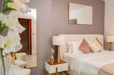 a bedroom with a white bed and a mirror at Elite Royal Apartment - Full Burj Khalifa & Fountain View - Largest Layout - Half Floor - Luxurious - Archon in Dubai