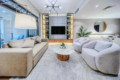 a living room with a couch and two chairs and a table at Zaafaran 1 by Emaar, Downtown Dubai in Dubai