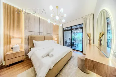 a bedroom with a large bed and a chandelier at Zaafaran 1 by Emaar, Downtown Dubai in Dubai