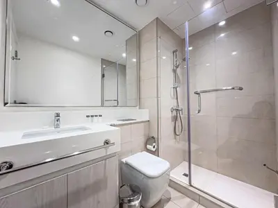 a bathroom with a shower and a toilet and a sink at Elegant 3 Bed in Park Point, Dubai Hills Estate in Dubai