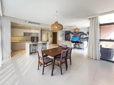 a kitchen and living room with a table and chairs at Elegant 3 Bed in Park Point, Dubai Hills Estate in Dubai