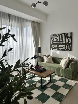 a living room with a green couch and a coffee table at Sea View Luxury 5242 Marina JBR Beach 5mins in Dubai