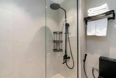a shower with a shower head in a bathroom at White Sage Incredible Studio Next to Metro in Dubai