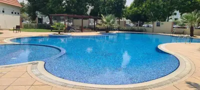 a large swimming pool with blue water at White Sage Incredible Studio Next to Metro in Dubai