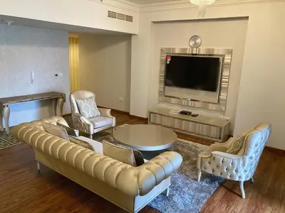 a living room with a couch and a tv at Executive Tower 1bhk Business Bay in Dubai