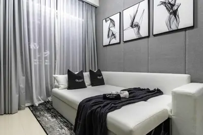 a room with a bed with two pillows on it at Luxury 2BD Apt with Pool GYM & Burj Khalifa Views in Dubai
