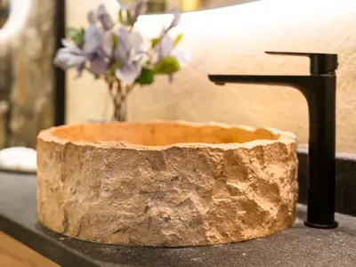 a bathroom sink with a wooden bowl and a faucet at Luxury Penthouse In The Heart of Dubai Marina in Dubai