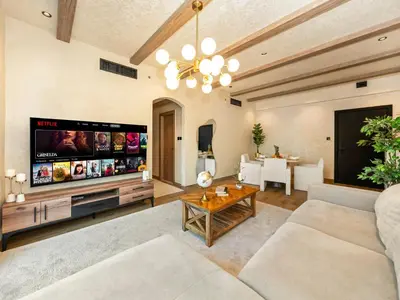a living room with a large flat screen tv at Luxury Penthouse In The Heart of Dubai Marina in Dubai
