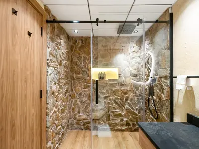 a stone wall in a bathroom with a shower at Luxury Penthouse In The Heart of Dubai Marina in Dubai