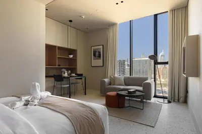 a bedroom with a bed and a living room at Upside Living Business Bay Stunning Panoramic Burj Cityline Views by Simply Comfort in Dubai