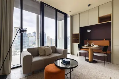 a living room with a couch and a table at Upside Living Business Bay Stunning Panoramic Burj Cityline Views by Simply Comfort in Dubai