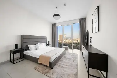 a bedroom with a large bed and a large window at FIRST CLASS 2BR Panoramic Views of Dubai Frame in Dubai