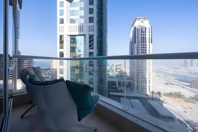 a chair on a balcony with a view of a city at Spectacular 1BR in Botanica Tower 1 Dubai Marina by Deluxe Holidy Homes in Dubai