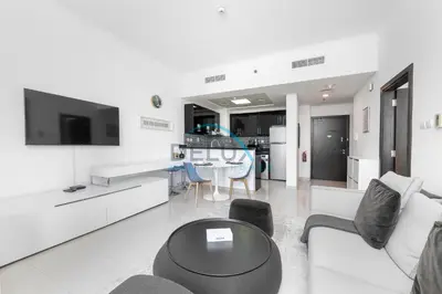 a white living room with a couch and a table at Spectacular 1BR in Botanica Tower 1 Dubai Marina by Deluxe Holidy Homes in Dubai