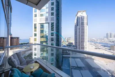 a balcony with chairs and a view of a city at Spectacular 1BR in Botanica Tower 1 Dubai Marina by Deluxe Holidy Homes in Dubai