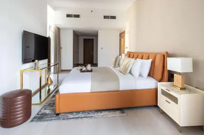 a bedroom with a large bed and a flat screen tv at Frank Porter - Urban Oasis in Dubai