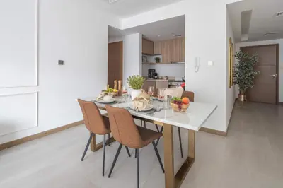 a kitchen and dining room with a table and chairs at Frank Porter - Urban Oasis in Dubai