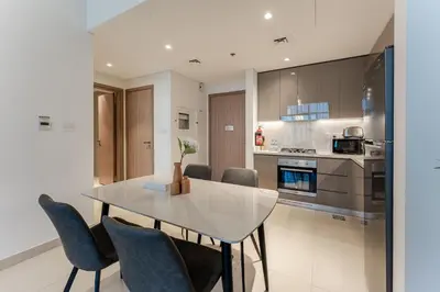 a kitchen and dining room with a table and chairs at HAVN - 1 Bedroom in Azizi Park Avenue, Meydan in Dubai