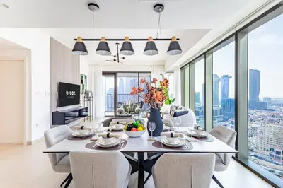 a dining room with a table and chairs with a view at Premium 3BR l Office with Burj Khalifa & Fountain Views in Dubai