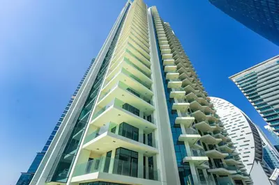 a tall apartment building with balconies and a blue sky at FAM Living - Urban Oasis 2bedroom, Business Bay in Dubai