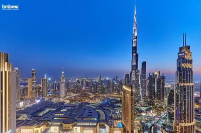 a view of a large city at night at bnbme - Luxury 4BR Downtown Views II Apt Burj Khalifa Views Pool Gym Parking in Dubai