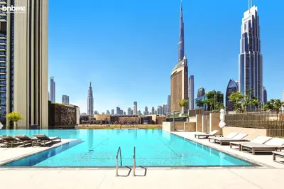 a swimming pool with a view of the city at bnbme - Luxury 4BR Downtown Views II Apt Burj Khalifa Views Pool Gym Parking in Dubai