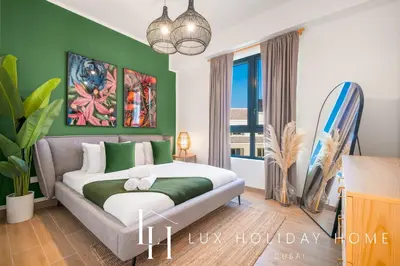 a bedroom with a bed and a surfboard at LUX The La Mer Infinity View- Luxury Boho Suite 2 in Dubai