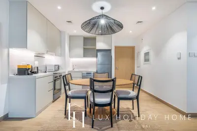 a kitchen and dining room with a table and chairs at LUX The La Mer Infinity View- Luxury Boho Suite 2 in Dubai