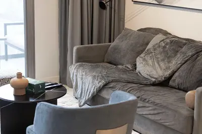 a living room with a couch and a table with chairs at MajeStay - MAG Living in Dubai
