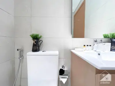 a bathroom with a sink and a toilet and a mirror at Luxury One Bedroom with Balcony & partial Burj Khalifa View in Dubai