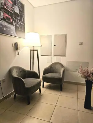 a waiting room with two chairs and a lamp at Room near to Lamer Beach Jumeirah one walk distance oima leasing property in Dubai