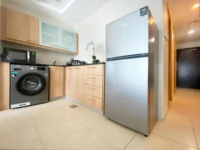 a kitchen with a refrigerator and a washing machine at Studio near beach and Metro in Dubai Marina Z1003 in Dubai
