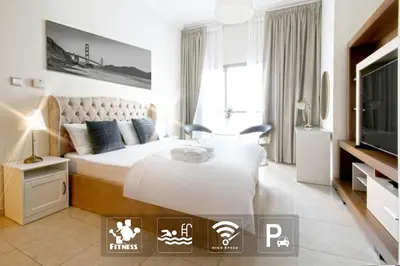 a hotel room with a bed and a tv at Stylist Studio in Marina near beach and Metro Z1103 in Dubai