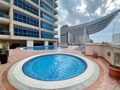 a large swimming pool in front of a building at Stylist Studio in Marina near beach and Metro Z1103 in Dubai