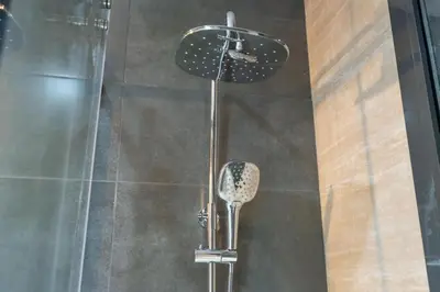 a shower stall with a shower head and a shower at SuCasa in Dubai