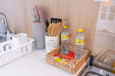 a basket with two bottles of water and some utensils at SuCasa in Dubai