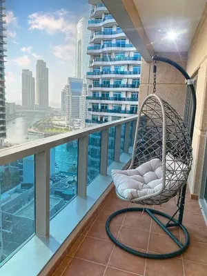 a chair on a balcony with a view of a city at 1Bedroom Apartment in Dubai Marina near to beach & Metro Z1006 in Dubai