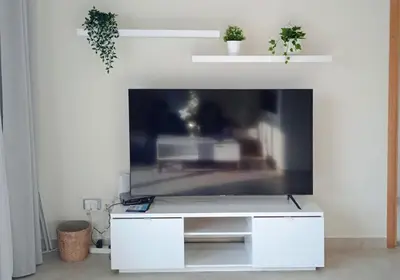 a living room with a large tv on a white wall at 1Bedroom Apartment in Dubai Marina near to beach & Metro Z1006 in Dubai