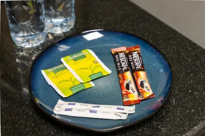 a blue plate with toothbrushes and toothpaste on a table at Stunning studio at sports city in Dubai