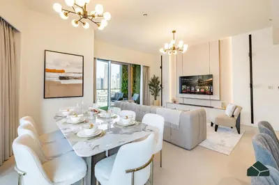 a dining room and living room with a table and chairs at Grande Signature Deluxe Next to Dubai Opera by BMS in Dubai