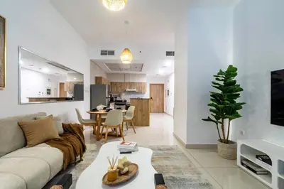 a living room with a couch and a table at ShoresInn - Dubai Marina's Classic Stay in Dubai