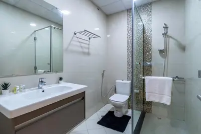 a bathroom with a sink and a toilet and a shower at ShoresInn - Dubai Marina's Classic Stay in Dubai