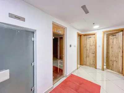 a room with a glass door and a red rug at ShoresInn - Dubai Marina's Classic Stay in Dubai