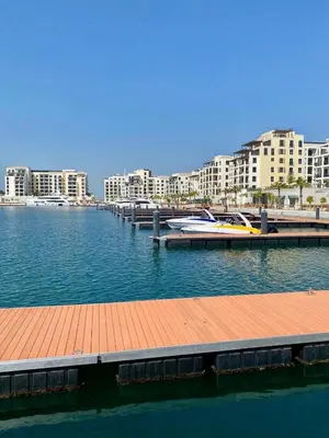 a marina with a dock in the water with buildings at La Mer Beach Jumeirah 1 bedroom hall Beach view balcony burj khalifa view walk distance few steps by oima leasing property in Dubai